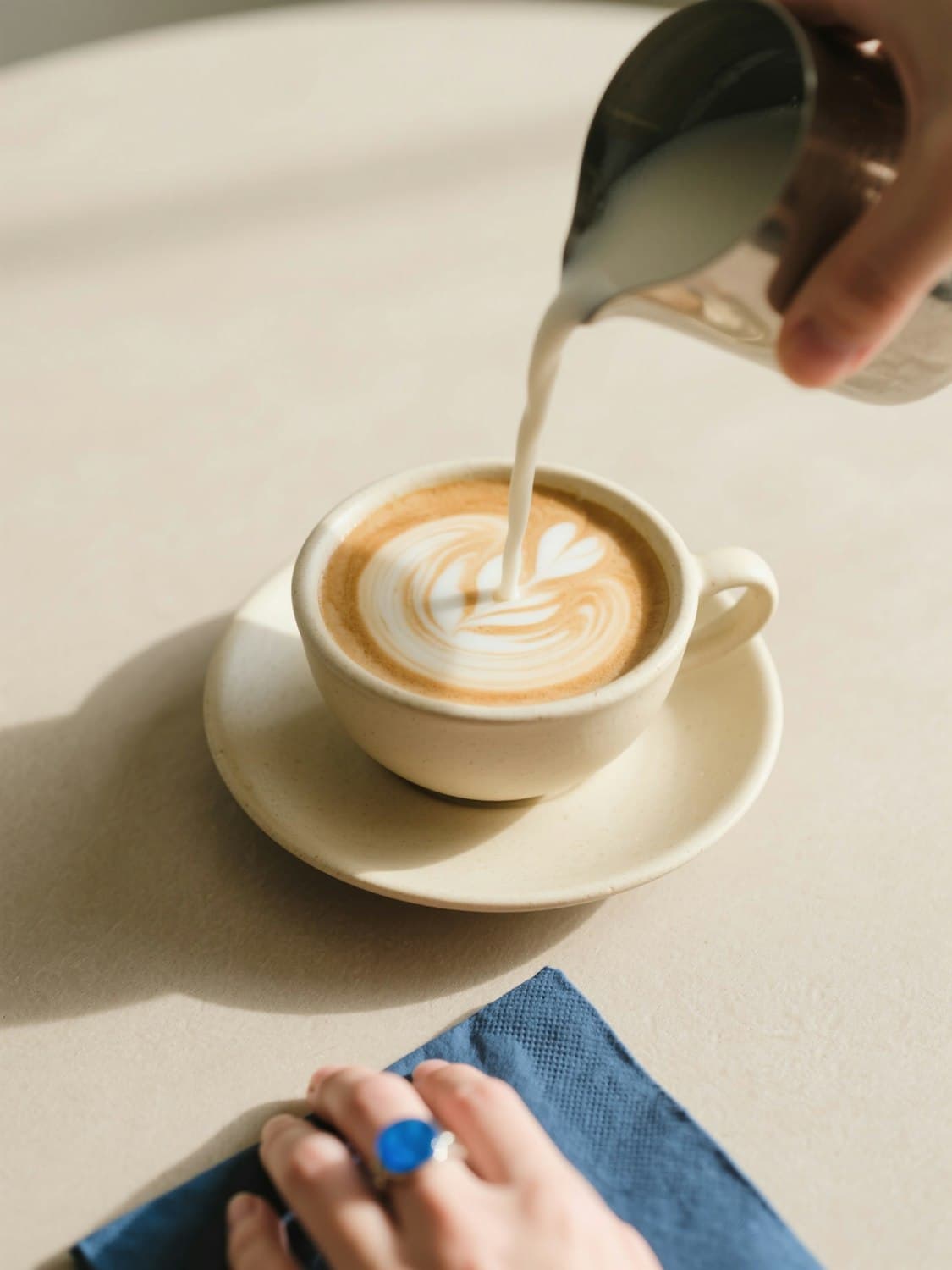 Milk being poured into a latte to make latte art
